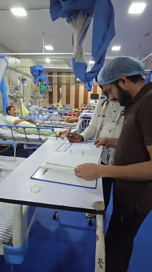 Dr. Rizvi writing notes during a ward round